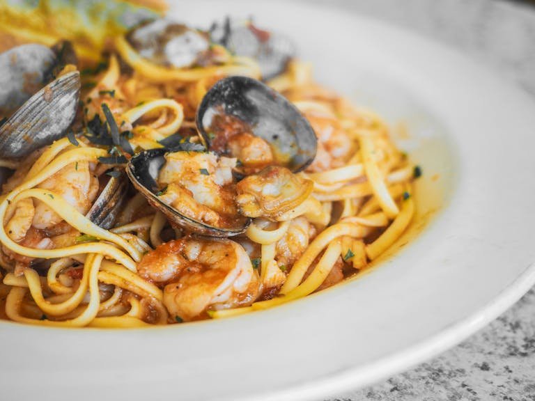 Delicious seafood linguine with fresh clams and shrimp in a savory sauce, perfect for pasta lovers.